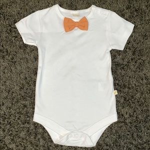 White onesie with mustard bow